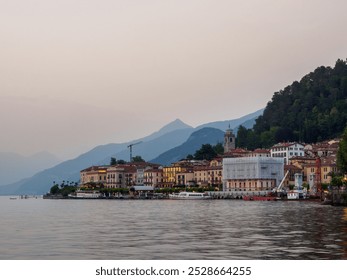 Picturesque waterfront village in Bellagio, Lake Como, featuring charming architecture with mountain backdrop. Captured at dusk, highlighting tranquil waters and serene evening atmosphere. - Powered by Shutterstock