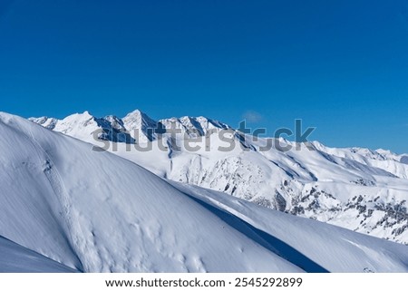 Picturesque winter landscape of the Arkhyz ski resort with mountains, snow, forest on sunny day. Caucasus Mountains, Russia.