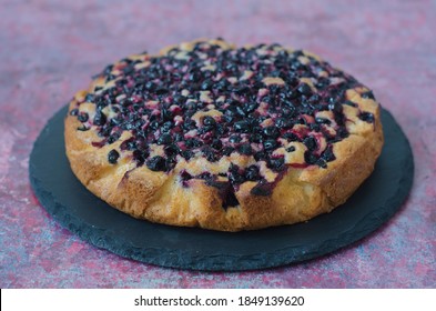 Pie with black currant and almond petals  