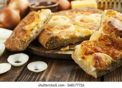 Pie with cheese and onion on the table - Shutterstock ID 568177726