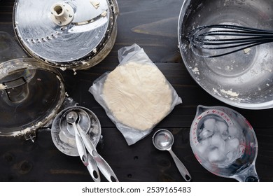 Pie Crust Dough Shaped into a Disc and Wrapped in Cling Film: Preparing homemade pie dough to be chilled by shaping into a disk in plastic wrap - Powered by Shutterstock