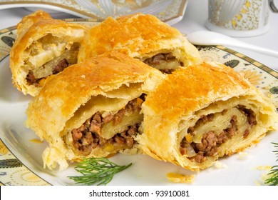 Pie With Ground Beef Filling, Rolls Of  Puff Pastry With Meat On Plate