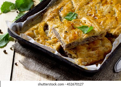 Pie With Meat (minced Meat And Puff Pastry) On The Table In A Rustic Style.