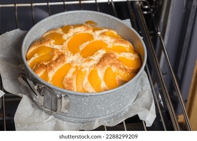 Pie with peaches is baked in a oven. Freshly baked peach pie in metal form - Powered by Shutterstock