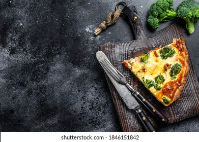 Pie tart with smoked salmon and broccoli. Black background. Top view. Copy space