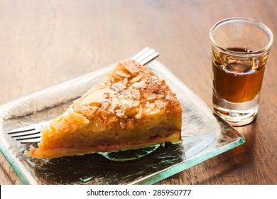 Piece Of Almond Cake In Dish With Honey Dip On Table.