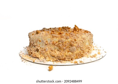 Piece Of Almond Cake With White Cream And Caramelized Nuts Isolate On White