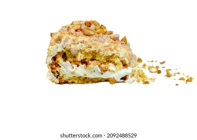 Piece Of Almond Cake With White Cream And Caramelized Nuts Isolate On White