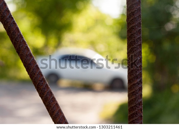 a piece of armored\
furniture in the foreground, against the background of the\
silhouette of a car