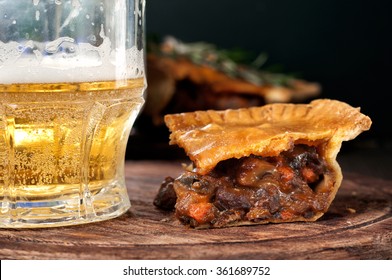 Piece Of Australian Meat Pie With A Glass Light Beer On The Table, Rustic Style