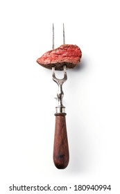 Piece Of Beef Steak On Meat Fork On White Background