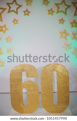 Piece of Birthday Chocolate Cake with Burning Candle as a Number Sixty on Brown Background