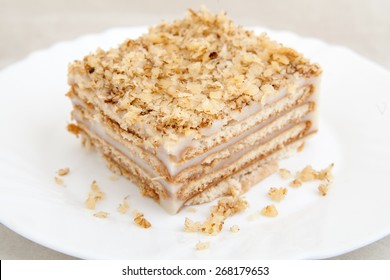 Piece Of Biscuit Cake On White Plate  