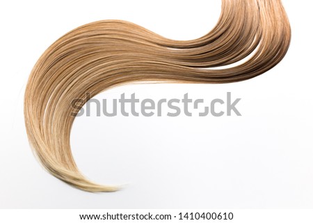 Piece of blonde hair on white isolated background. Wavy shape. Hair care, healthy hair