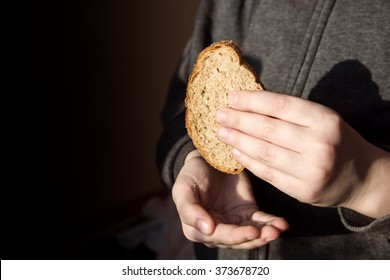 Piece Of Bread In Children Hands. Hunger And Helping Concept.