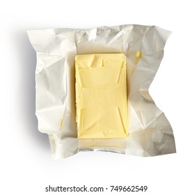 Piece of butter isolated on white background, top view