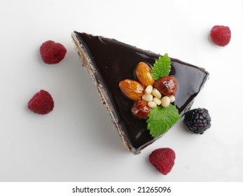 Piece Of Cake With Nuts Coated With Chocolate Icing (view From Above)