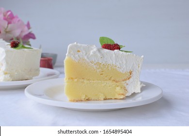 piece of cake  on white plate and white cotton placemat background.
