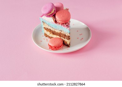 Piece Of Cake With Pink And Blue Decor On White Plate On Pink Background