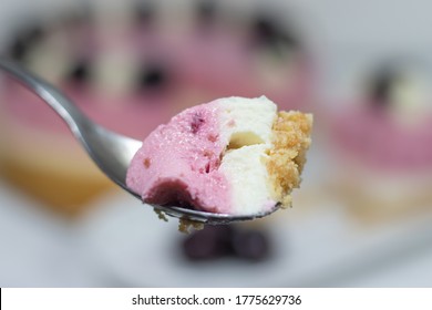 Piece Of Cheery Cheesecake On A Tea Spoon.