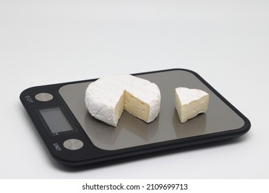 A Piece Of Cheese On The Scales. Weight Loss, Diet And Weight Control. Still Life With Healthy Food And Scales. Healthy Food. The Concept Of A Healthy Lifestyle. Weight Control During Self Isolation