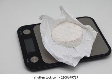 A Piece Of Cheese On The Scales. Weight Loss, Diet And Weight Control. Still Life With Healthy Food And Scales. Healthy Food. The Concept Of A Healthy Lifestyle. Weight Control During Self Isolation