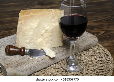 Piece of cheese Parmesan cheese with red wine