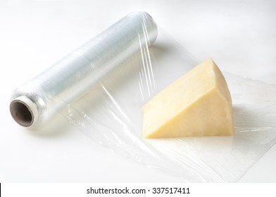 Piece Of Cheese Wrapped With  Cellophane Film For Protection.