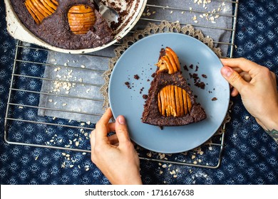 A piece of chocolate baked apple, fruit and nuts brownie. Sweet vegan brown dessert cake, pie. Breakfast