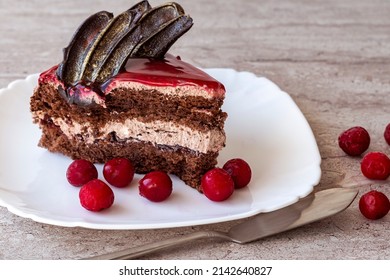 A Piece Of Chocolate Cake With Cherries. Cake Side View On A Beige Background. Copy Space.