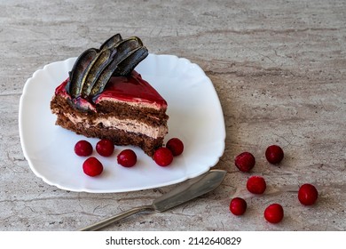 A Piece Of Chocolate Cake With Cherries. Cake Side View On A Beige Background. Copy Space.