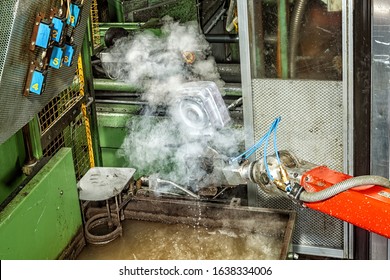 A Piece Coming Out Of A Die Casting Machine Has Just Been Cooled