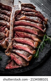 Piece Of Cooked T-bone Or Aged Wagyu Porterhouse Grilled Beef Steak With Spices Served On On Stone Board. Vertical Image. Place For Text,