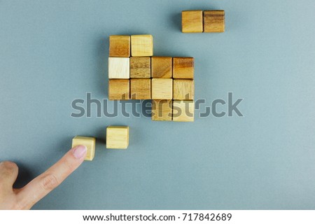 piece of cube wood block missing in hand, symbolizing to business concept of uncomplete, need to fit, solving problem, last piece of solution.