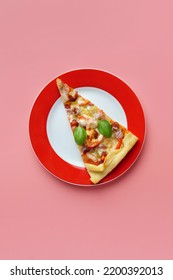 A piece of delicious homemade pizza on a plate on a pink background, close-up. - Shutterstock ID 2200392013