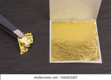 Piece Of Edible Gold Leaf Held By Tweezers