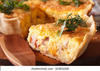 A piece of French quiche Lorraine on the cutting board macro. horizontal