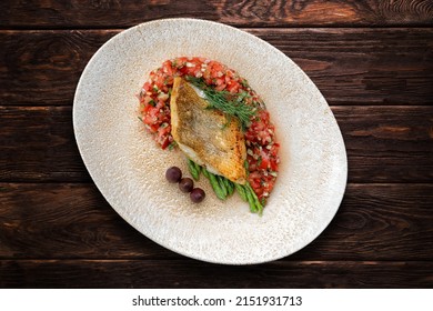 A piece of fried fish pike perch with vegetables, fillet