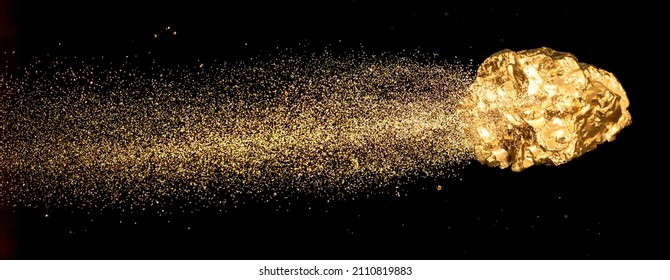 Piece of gold or golden nugget with visible gold shining comet tail ath the dark background.  - Shutterstock ID 2110819883
