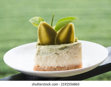 A Piece Of Green Tea And Sesame Cake. Green Tea And Sesame Cake.
 Side View, Close Up.