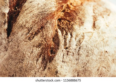A piece of handmade freshly baked rye bread, texture background, closeup.