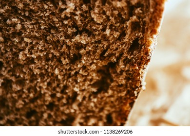 A piece of handmade freshly baked rye bread, texture background, closeup.