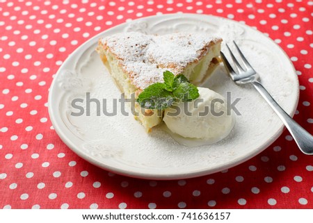 A piece of homemade Apple pie with vanilla ice cream and mint