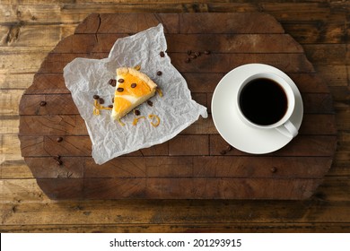 Piece Of Homemade Orange Tart On Paper Napkin, On Color Wooden Background