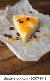 Piece Of Homemade Orange Tart On Paper Napkin, On Color Wooden Background