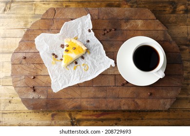 Piece Of Homemade Orange Tart On Paper Napkin, On Color Wooden Background