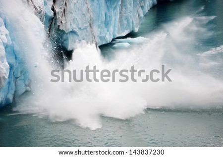 A piece of ice falling from the Perito Moreno glacier in Argentina with the splashes of water