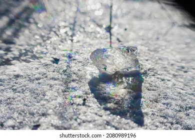 Piece Of Ice On The Snow. Diffraction Effect. Pure, Unusual, Miracle Concept.