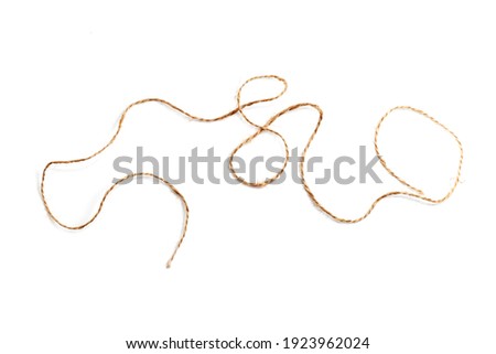 Piece of jute twine isolated on white background. Natural rope for packaging and decoration. Coarse linen threads. Hemp twine.