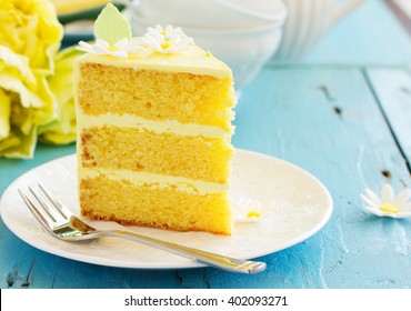 A piece of lemon sponge cake on a plate.